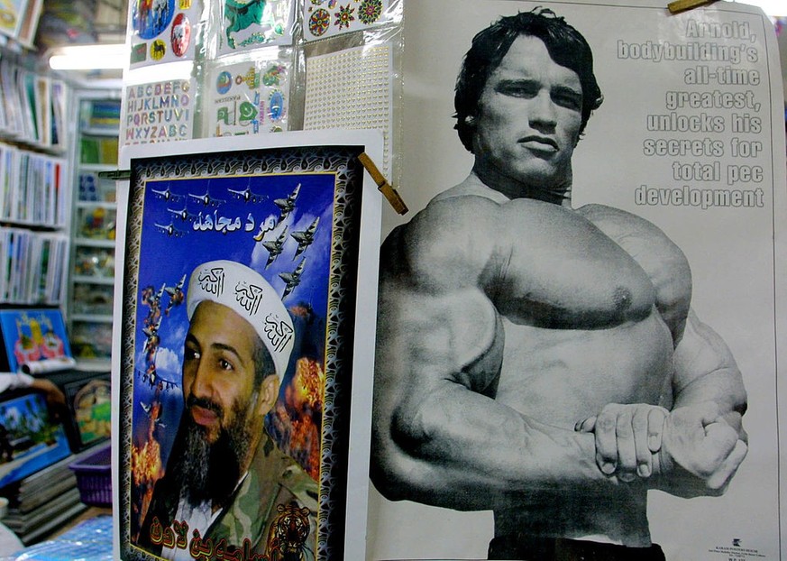 396191 09: A poster of actor Arnold Schwarzenegger is for sale alongside one of Osama bin Laden October 20, 2001 in the main bazaar in Quetta, Pakistan. Sales of bin Laden merchandise have been on the ...