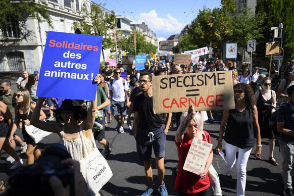 Anti-speciesism activists hold banners and posters, during a march for the 8th World Day for the End of Speciesism (WoDES), in Lausanne, Switzerland, Saturday, August 27, 2022. The World Day for the E ...