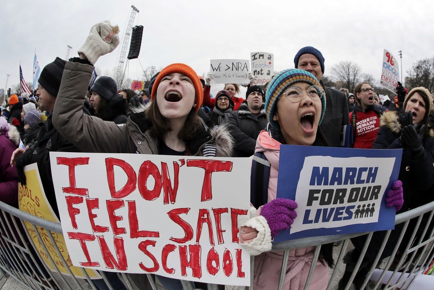 FILE - Demonstrators hold signs during a &quot;March for Our Lives&quot; rally in support of gun control, Saturday, March 24, 2018, in Chicago. In the wake of the shooting at Marjory Stoneman Douglas  ...