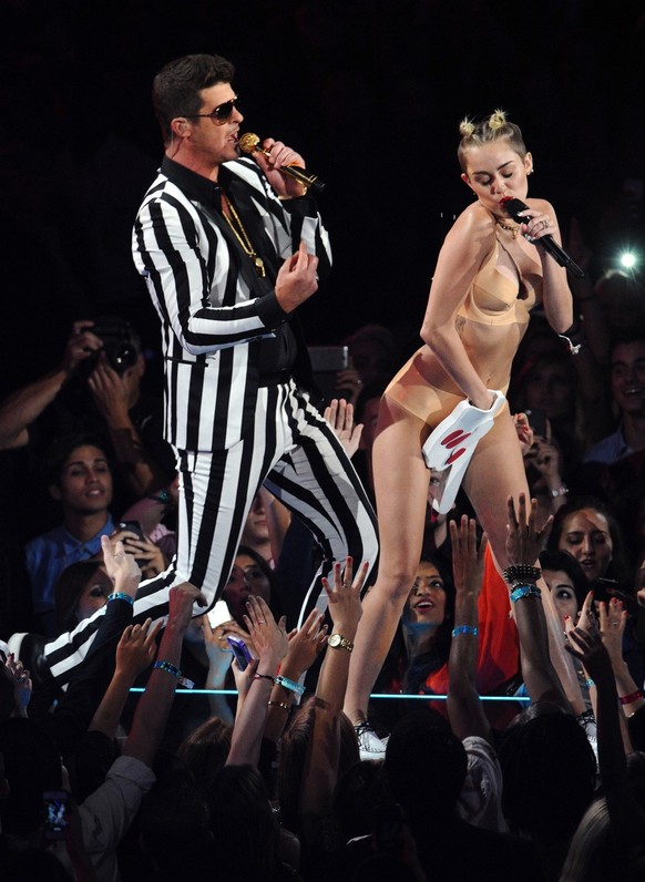 Robin Thicke, left, and Miley Cyrus perform &quot;Blurred Lines&quot; at the MTV Video Music Awards on Sunday, Aug. 25, 2013, at the Barclays Center in the Brooklyn borough of New York. (Photo by Char ...