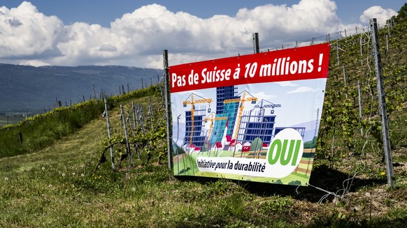 An electoral poster for the right-wing Swiss People's Party (SVP) popular initiative "No 10-million-Switzerland" is pictured in a vineyard owned by Olivier Agassis, a winemaker and memb ...