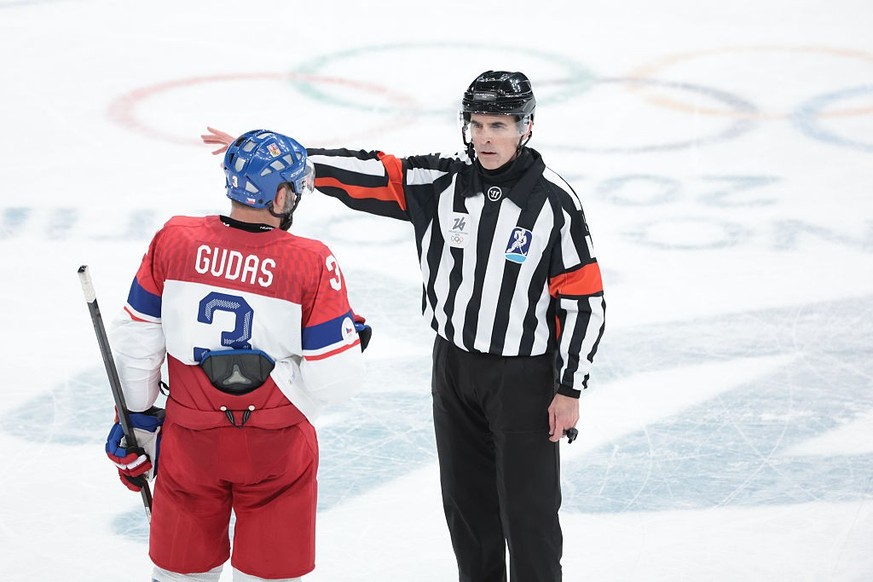 MILAN, ITALY - FEBRUARY 18 : Referee Chris Rooney #5 speaks to Radko Gudas #3 after he sends Michal Kempny #6 of Czech Republic to the penalty box (sin bin) during the Ice Hockey Men's Play-offs  ...