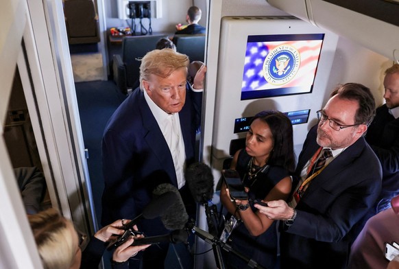 U.S. President Donald Trump rspeaks to members of the media on board Air Force One en route from Scotland, Britain, to Joint Base Andrews, Maryland, U.S., July 29, 2025. REUTERS/Evelyn Hockstein