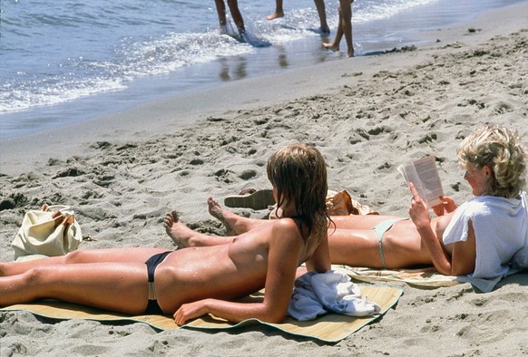 Topless on the beach in Marbella, 1977, Malaga, Andalusia, Spain. (Photo by Gianni Ferrari/Cover/Getty Images).