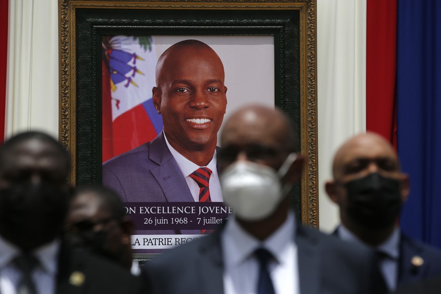 FILE - In this July 20, 2021 file photo, authorities pose for a group photo in front of the portrait of late Haitian President Jovenel Moise at at the National Pantheon Museum during his memorial serv ...