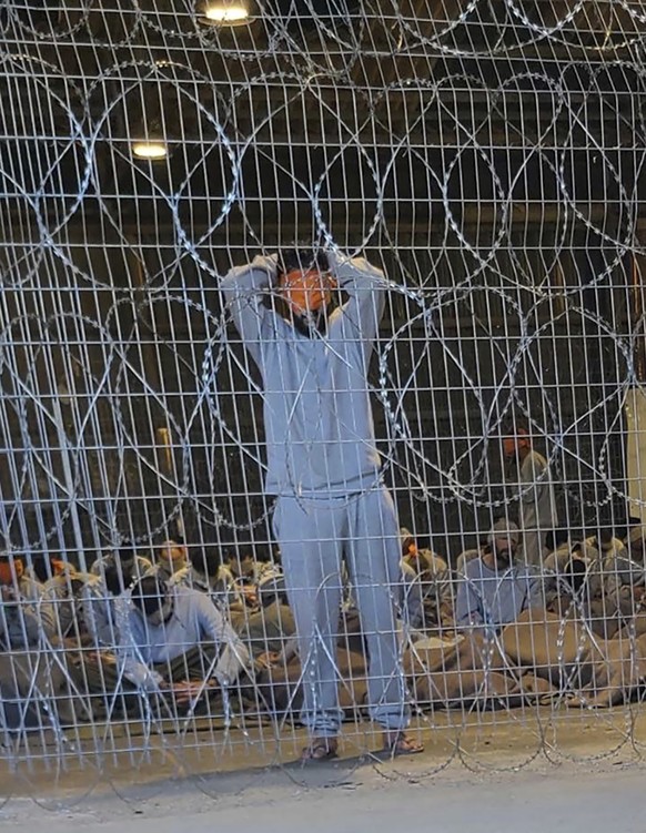 This undated photo from Winter 2023 provided by Breaking The Silence shows blindfolded Palestinian prisoners captured in the Gaza Strip by Israeli forces at a detention facility on the Sde Teiman mili ...