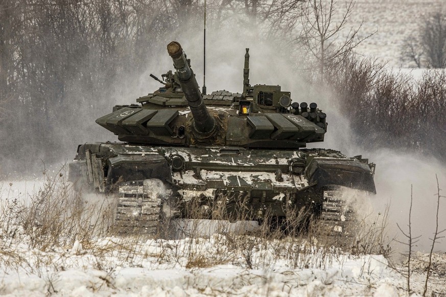 In this photo provided by the Russian Defense Ministry Press Service on Monday, Feb. 14, 2022, A Russian tank rolls on the field during military drills in Leningrad region, Russia. (Russian Defense Mi ...