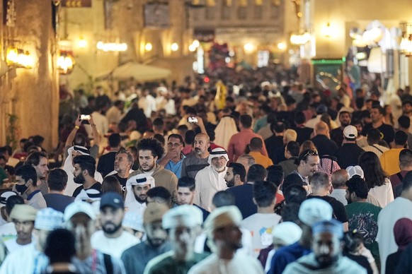 Thousand of locals and visitors walk the streets at the Souq Waqif marketplace during the Soccer World Cup in central Doha, Qatar, on Wednesday, Dec. 7, 2022. (AP Photo/Martin Meissner)