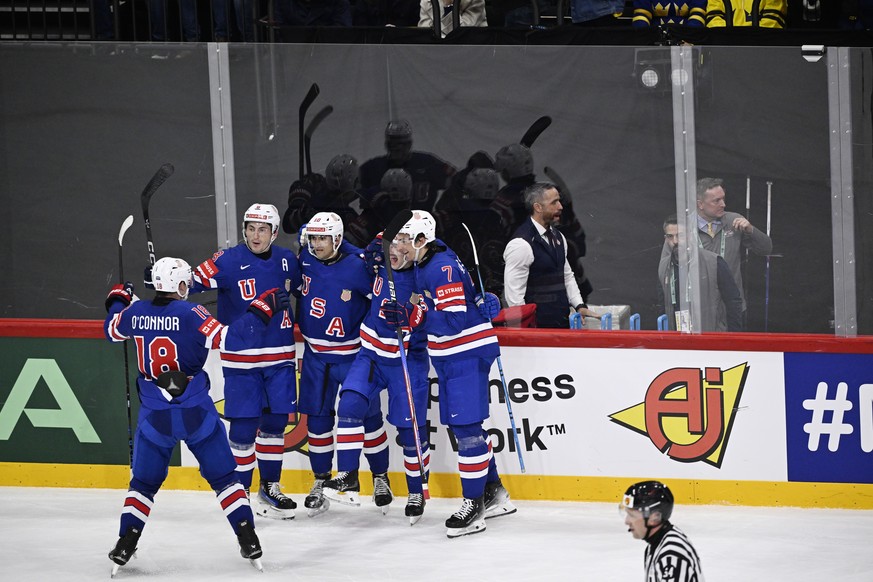 epa12130849 Players of the US celebrate scoring their fourth goal during the IIHF Ice Hockey World Championship semifinal match between Sweden and the USA at Avicii Arena in Stockholm, Sweden, 24 May  ...