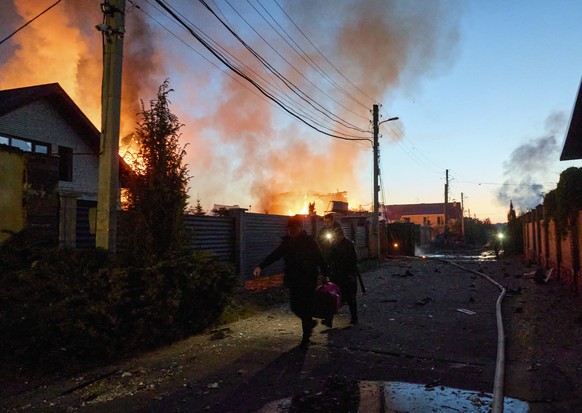 epa11330777 Ukrainian rescuers work to extinguish a fire at the site of an overnight missile strike on private buildings in Kharkiv, northeastern Ukraine, 10 May 2024, amid the Russian invasion. Khark ...