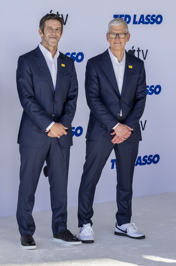 epa13136518 John Ternus (L) and Tim Cook (R) arrive for the world premiere of the fourth season of the television series 'Ted Lasso' at the Academy Museum of Motion Pictures in Los Angeles,  ...