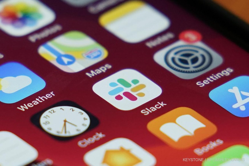 The Slack app icon is displayed on an iPhone screen, Tuesday, Dec. 1, 2020, in Long Beach, Calif. In a deal announced Tuesday, business software pioneer Salesforce.com is buying work-chatting service  ...