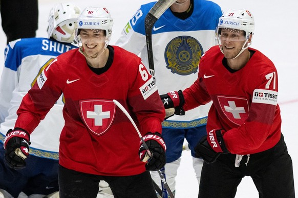 Switzerland&#039;s Fabrice Herzog, left, and Enzo Corvi celebrate the goal to 3-1 during the Ice Hockey World Championship group A preliminary round match between Switzerland and Kazachstan in Helsink ...