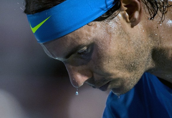 Sweat pours off the face of Rafael Nadal of Spain as he plays Kei Nishikori of Japan during the quarter finals at the Rogers Cup tennis tournament Friday Aug. 14, 2015 in Montreal. (Paul Chiasson/The  ...