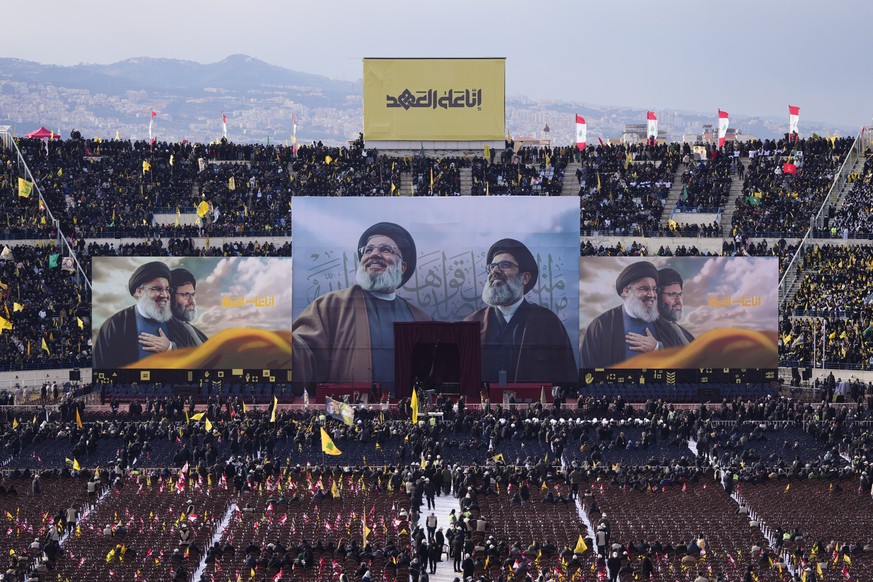 Images depicting the Hezbollah&#039;s former leader Hassan Nasrallah, center left, and his cousin and successor Hashem Safieddine are displayed during their funeral ceremony at the Sports City Stadium ...