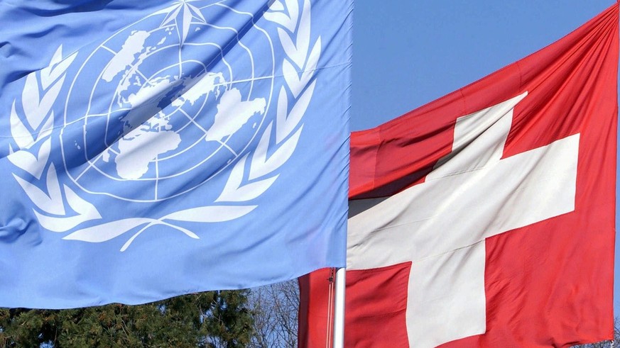 Les drapeaux de l' Organisation des Nations Unies ONU, dgauche, et le drapeau de la Confederation Helvetique, droite, ce 20 mars 2000 devant le siege de l' Organisation meteorologique mondia ...