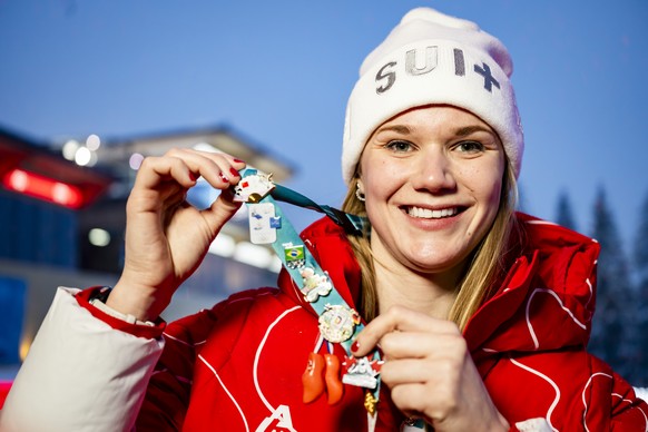 Natalie Maag of Switzerland poses with her pin badge collection during a media conference of the Swiss luge team prior to the 2026 Olympic Winter Games in Cortina d'Ampezzo, Italy, on Wednesday,  ...