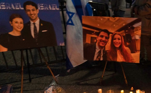 People gather to light candles in a makeshift memorial to honor Yaron Lischinsky and Sarah Milgrim who were killed as they left an event at the Capital Jewish Museum in Washington, during a candleligh ...