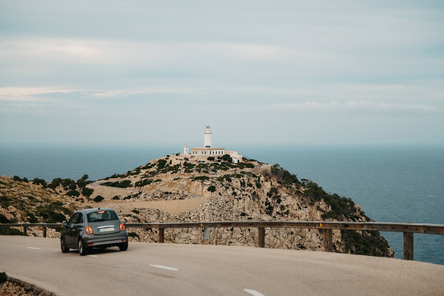 Car Driving Toward Cap de Formentor Lighthouse on Scenic Coastal Road Pollença, Balearic Islands, Spain CR_EPZT260218B-1968361-01