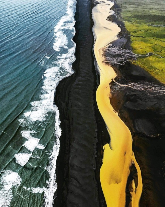 There&amp;#039;s a place in Iceland where green fields, a yellow river, a black beach and the ocean meet.