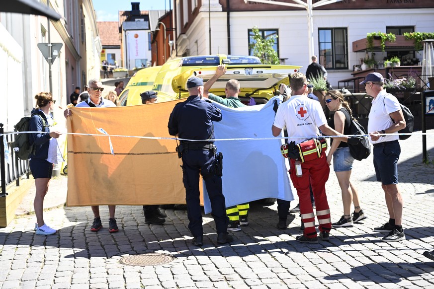 epa10055343 Emergency personnel at the scene where a woman has been seriously injured in a stabbing at the Almedalen political festival on the Swedish island of Gotland, Visby, Sweden, 06 July 2022. A ...