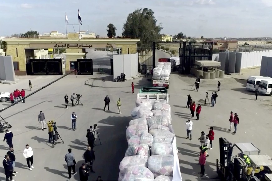 In this image taken from a video released by the Egyptian Government Press Center trucks of aid enter the Gaza Strip through the Rafah crossing in Rafah, Egypt, Sunday January. 19, 2025. (Egyptian Pre ...