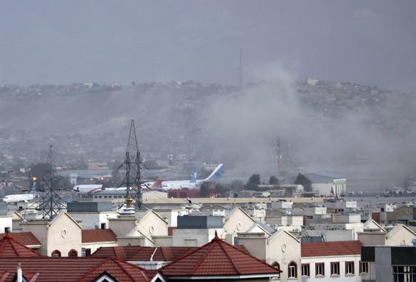 Smoke rises from explosion outside the airport in Kabul, Afghanistan, Thursday, Aug. 26, 2021. The explosion went off outside KabulÄôs airport, where thousands of people have flocked as they try to f ...