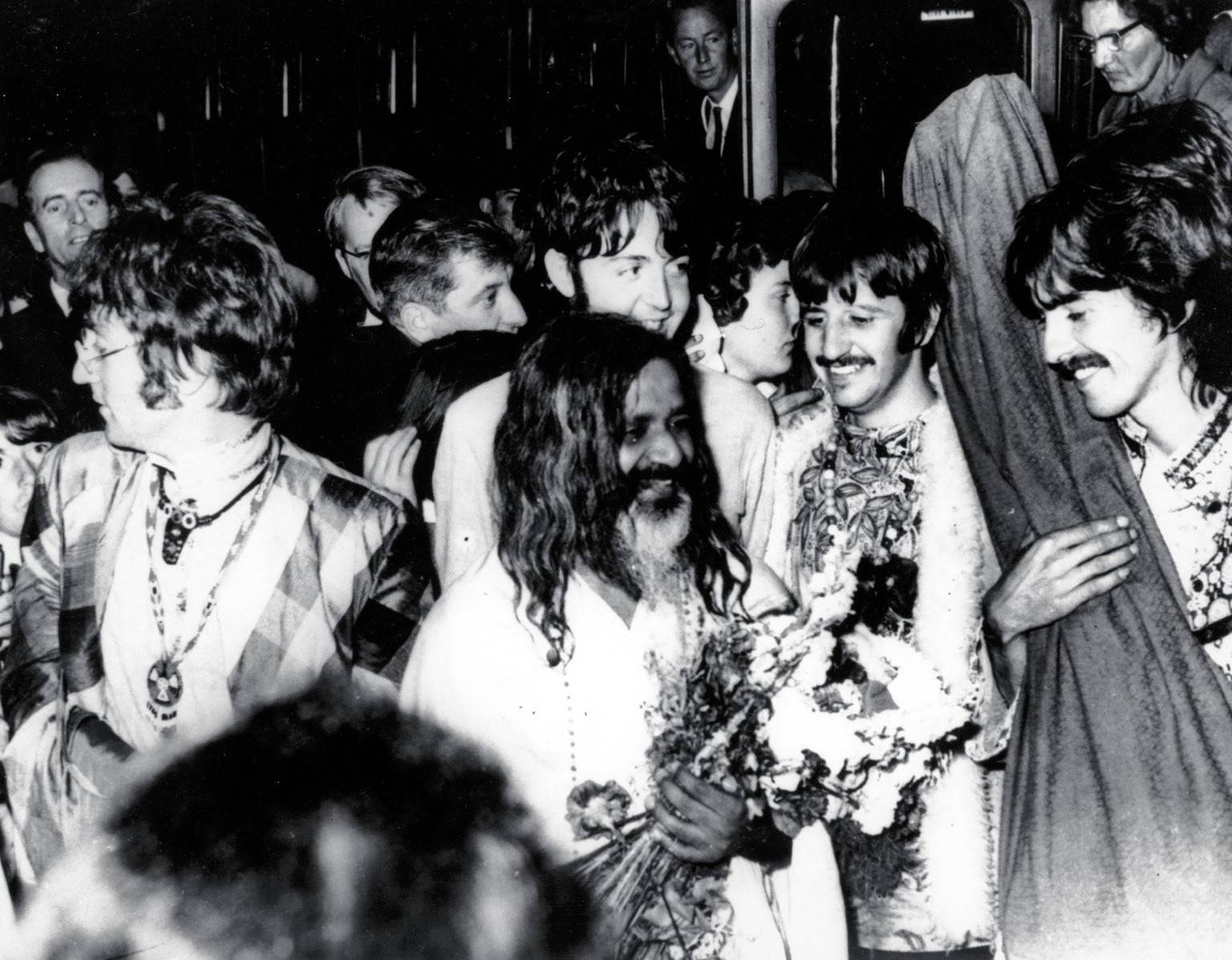 The Beatles join the Maharishi Mahesh Yogi, center, as they arrive by train at Bangor, Wales, to participate in a weekend of meditation, in this August 26, 1967, file photo. From left to right are, Jo ...