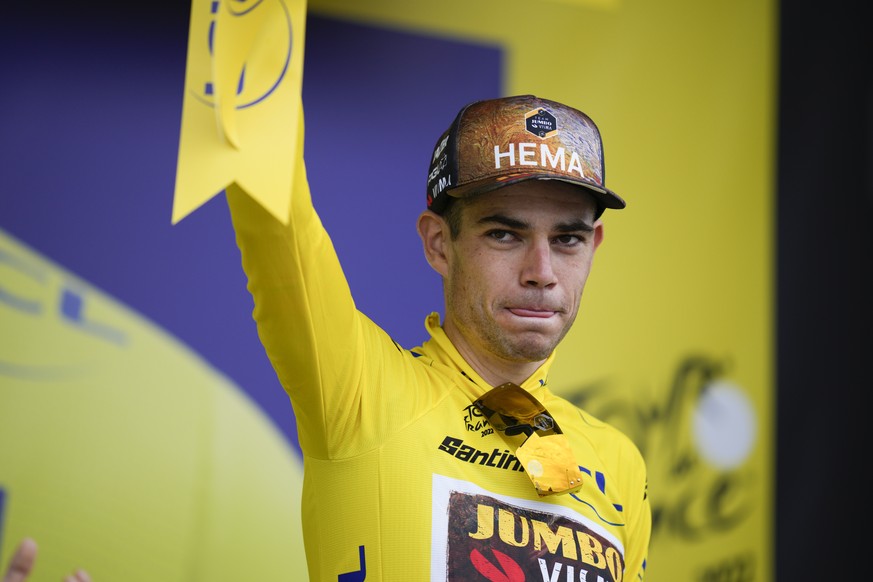 Belgium&#039;s Wout Van Aert, wearing the overall leader&#039;s yellow jersey, celebrates on the podium after the third stage of the Tour de France cycling race over 182 kilometers (113 miles) with st ...