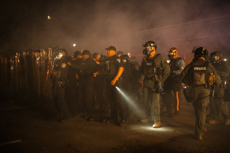 KEYPIX - epa13006083 New Jersey State Police officers shine lights as they clear a protest at the Delaney Hall Detention Facility, in Newark, New Jersey, USA, 30 May 2026. About 300 detainees at the D ...