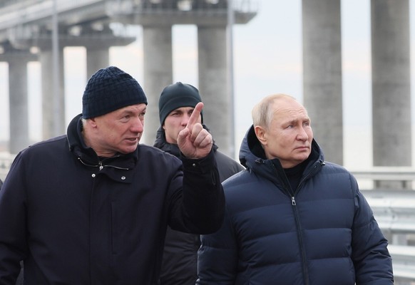 epa10349737 Russian President Vladimir Putin (2-L) and Russian Deputy Prime Minister Marat Khusnullin (L) visit the Kerch Strait Bridge, Crimea, 05 December 2022. The motorway of the Crimean Bridge wa ...