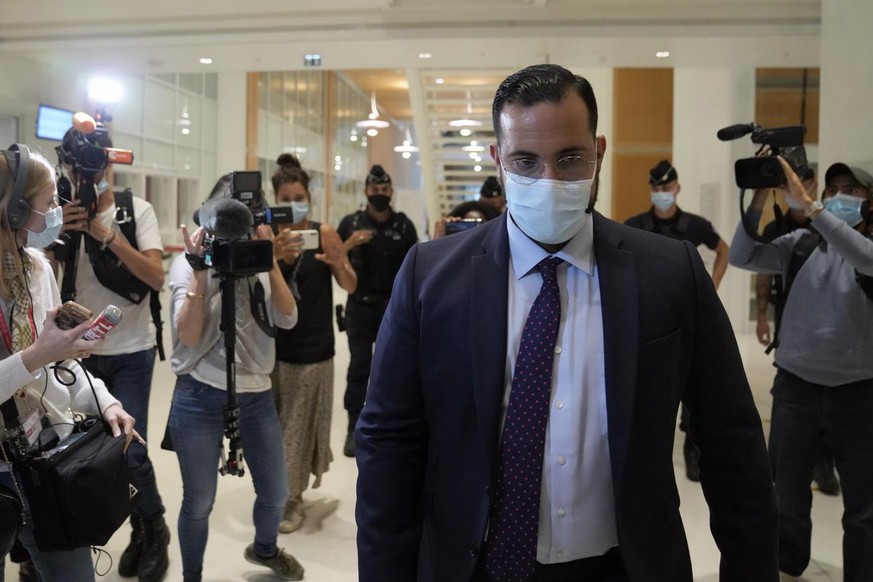 Alexandre Benalla, 30, a former security aide to President Emmanuel Macron leaves the court house on the first day of trial in Paris, Monday, Sept. 13, 2021. Benalla who triggered a political crisis w ...