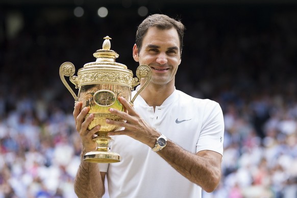 Roger Federer of Switzerland celebrates with the trophy after winning the men&#039;s final match against Marin Cilic of Croatia during the Wimbledon Championships at the All England Lawn Tennis Club,  ...