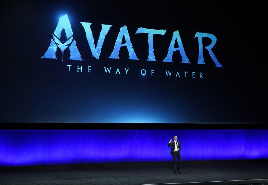 Tony Chambers, executive vice president of theatrical distribution for Walt Disney Studios, speaks underneath a graphic for the upcoming film &quot;Avatar: The Way of Water&quot; during the Walt Disne ...