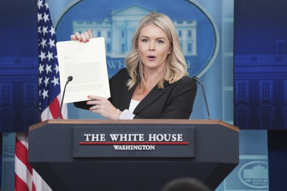 White House press secretary Karoline Leavitt speaks as she holds up a letter from President Donald Trump to Japan&#039;s Prime Minister Shigeru Ishiba during a press briefing at the White House, Monda ...