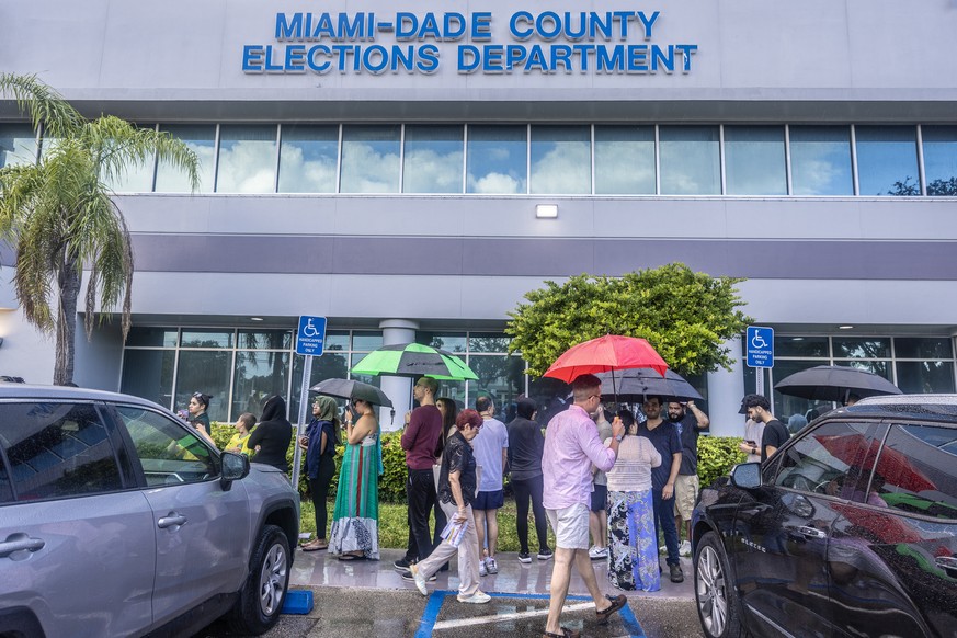 epa11699994 People wait in line to vote on Florida&#039;s last early voting day for the 2024 presidential election in Florida, at the Miami-Dade County Elections Department in Miami, Florida, USA, 03  ...