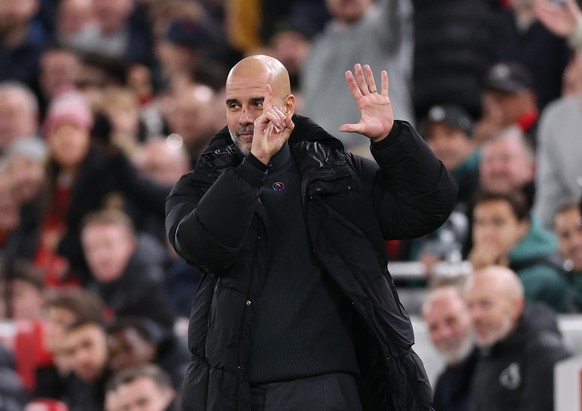 epa11752128 Manchester City manager Pep Guardiola gestures towards Manchester City fans during the English Premier League match between Liverpool and Manchester City in Liverpool, Britain, 01 December ...