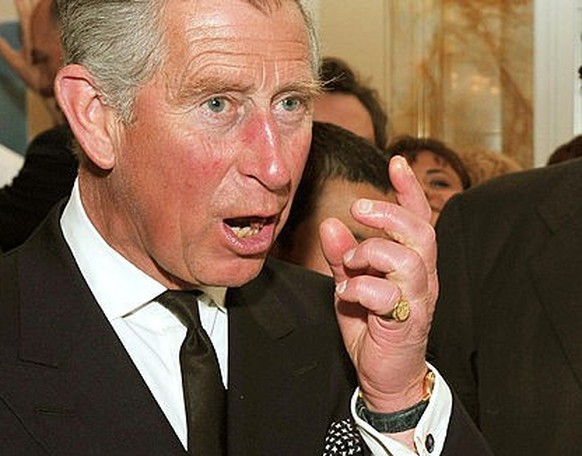 ROME - APRIL 27: Prince Charles, Prince of Wales (L) tries some beef prepared by chef Carlo Cracco (R) during an organic food reception at the British Ambassador&#039;s residence on April 27, 2009 in  ...