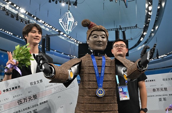 Winner of the dance event from Beijing Dance Academy and Hubei Optics Valley Dongzhi poses during the award ceremony at the World Humanoid Robot Games in Beijing on August 15, 2025. (Photo by ADEK BER ...