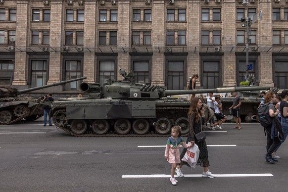 epa10130452 People pass Russian armoured military vehicles that were damaged in fights with the Ukrainian army, displayed on Khreshchatyk street, in downtown Kyiv, ahead of the &#039;Independence Day& ...
