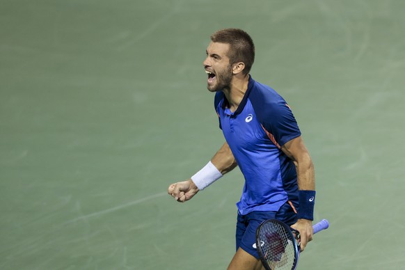 Borna Coric, of Croatia, yells after defeating Félix Auger-Aliassime, of Canada, during the Western &amp; Southern Open tennis tournament, Friday, Aug. 19, 2022, in Mason, Ohio. (AP Photo/Aaron Doster ...