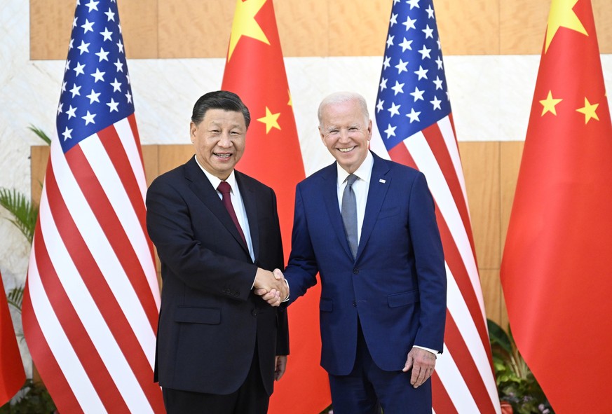 epa10305493 Chinese President Xi Jinping (L) greets his US counterpart Joe Biden before their meeting, one day ahead of the G20 Summit in Bali, Indonesia, 14 November 2022. The 17th Group of Twenty (G ...
