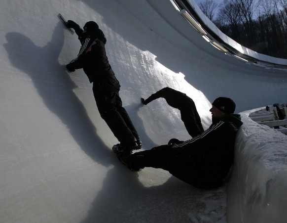 Track workers make repairs to the course during two-man Bobsled World Championships in Lake Placid, N.Y., Saturday, Feb. 21, 2009. (AP Photo/Mike Groll)