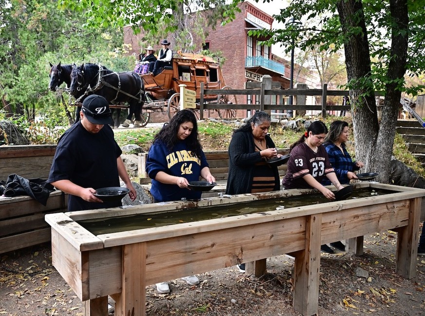 People pan for gold at the Matelot Gulch Mining Company on October 26, 2025 in the Sierra Nevada foothills town of Columbia, California. Though the value of gold has fluctuated, it has effectively dou ...