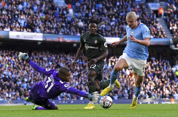 Southampton goalkeeper Gavin Bazunu saves at the feet of Manchester City&#039;s Erling Haaland during the English Premier League soccer match between Manchester City and Southampton at Etihad stadium  ...