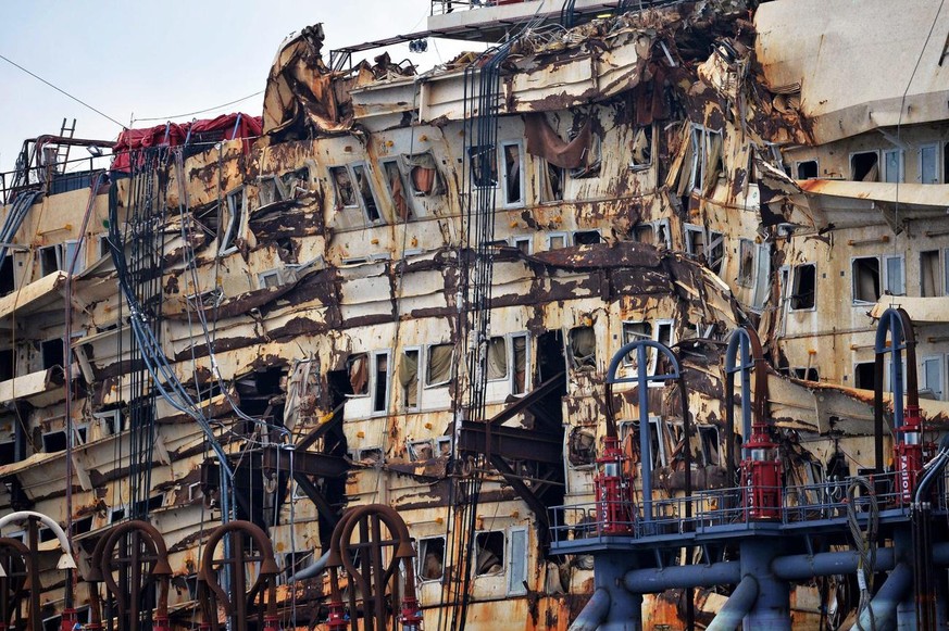 epa04334065 The Italian cruise liner Costa Concordia sits in a dock inside of Voltri Port in Genoa, Italy, 28 July 2014. The Costa Concordia dismantling operations are predicted to last two years. The ...