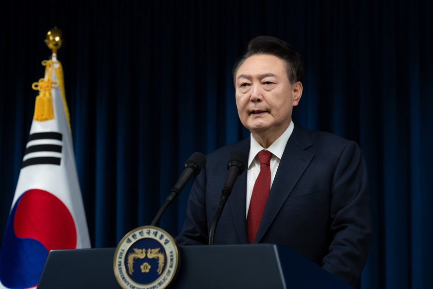 epa11761476 A handout photo made available by the South Korean Presidential Office shows President Yoon Suk Yeol addressing the nation at the Presidential office in Seoul, South Korea, 07 December 202 ...
