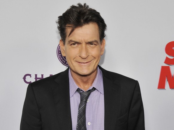 FILE - In this April 11, 2013, file photo, Charlie Sheen, a cast member in &amp;quot;Scary Movie V,&amp;quot; poses at the Los Angeles premiere of the film at the Cinerama Dome in Los Angeles. Sheen f ...