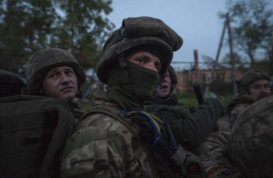 Ukrainian soldiers sit in a pickup truck at their position on the frontline close to Bakhmut, Donetsk region, Ukraine, Friday, June 16, 2023. (Iryna Rybakova via AP)