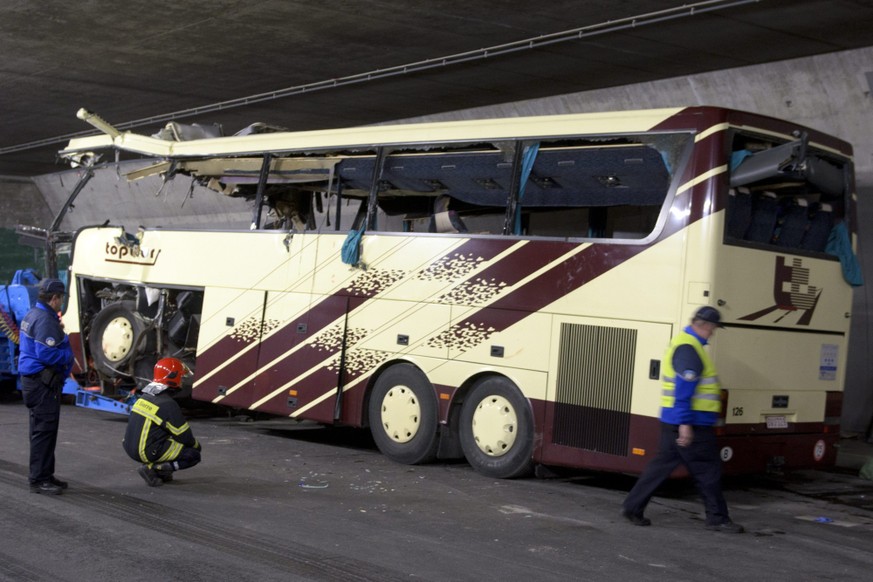 The wreckage of a tourist bus from Belgium is seen at the accident site in a tunnel of the motorway A9, in Sierre, western Switzerland, early Wednesday, March 14, 2012. 28 people were killed, 6 adults ...